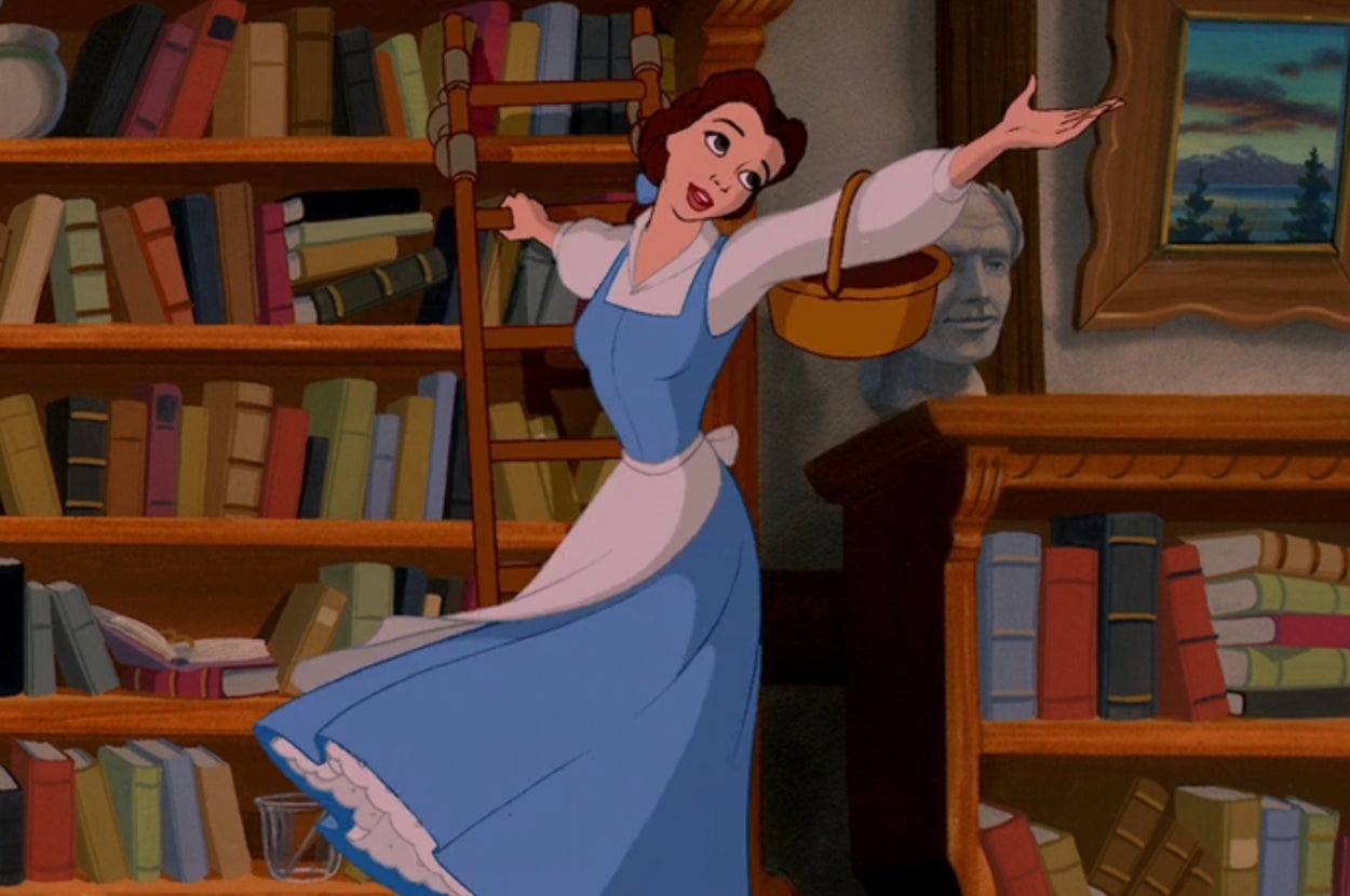 Belle from Beauty and the Beast joyfully dances in a library