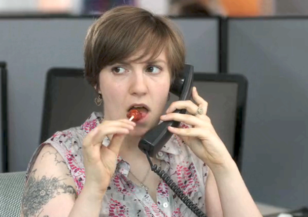 hannah horvath on the phone eating a lollipop