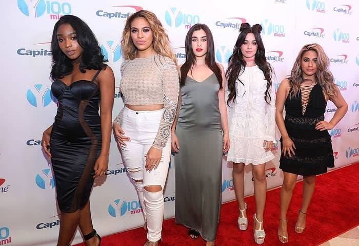 Five women pose on a red carpet at a Miami event, wearing various stylish dresses with different cuts and lengths