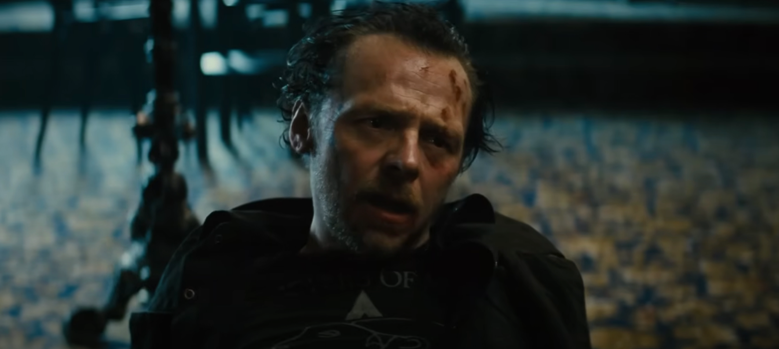 Simon Pegg sitting on the floor, blood smeared on his forehead, in "The World's End"