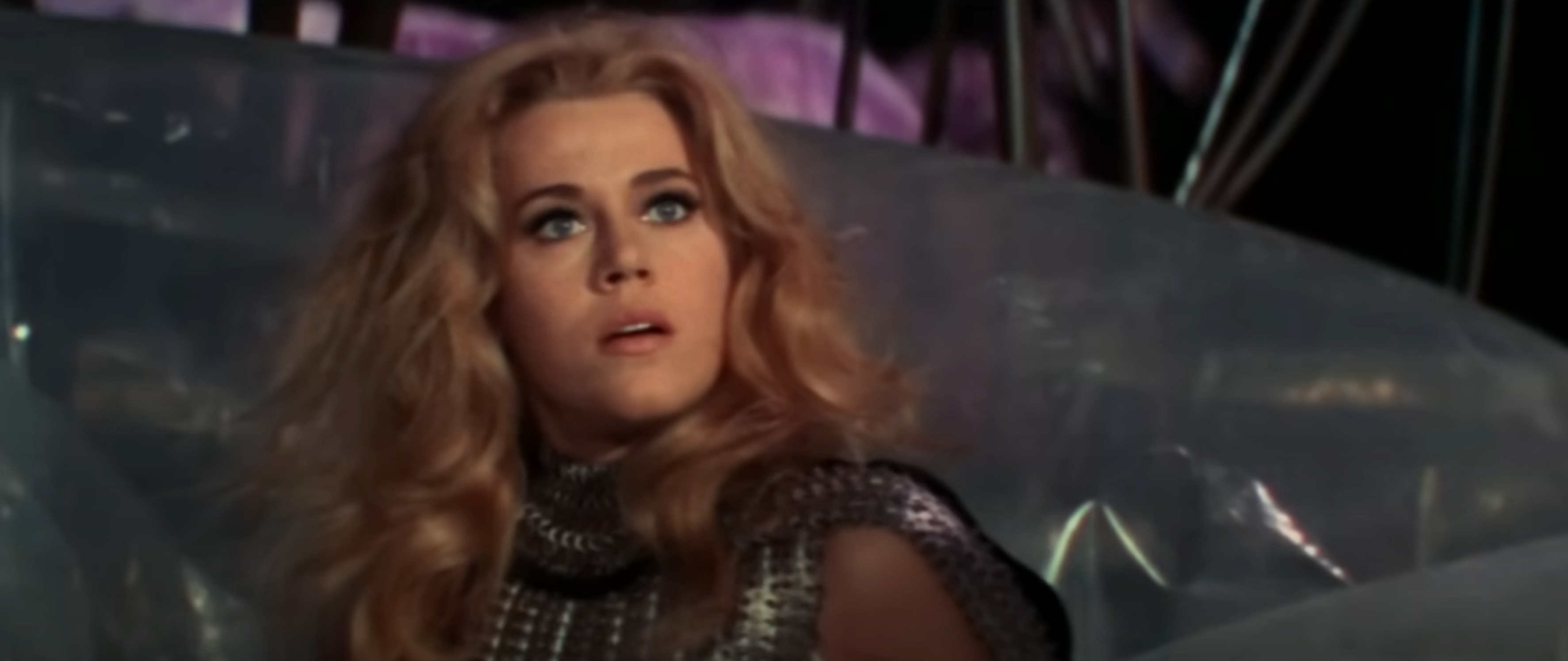 Jane Fonda stares into the distance with a surprised expression in "Barbarella"
