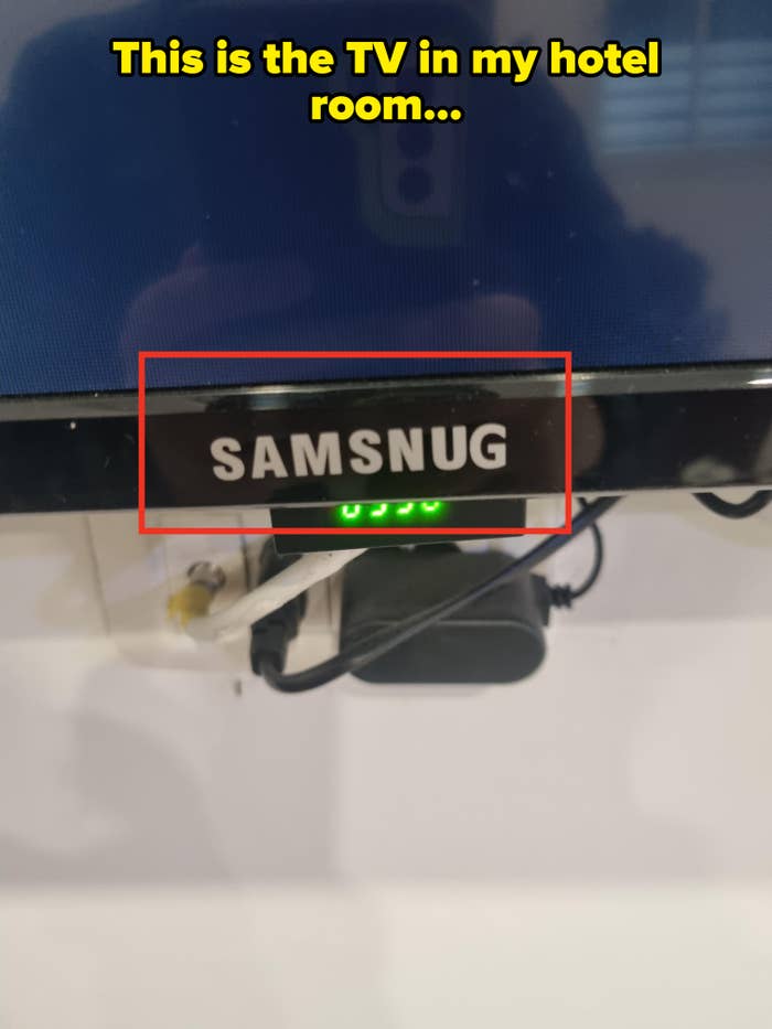 A TV screen displays the word "SAMSNUG" instead of "SAMSUNG," suggesting a humorous spelling error