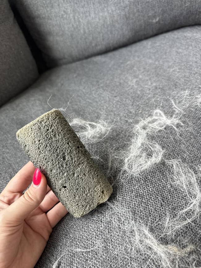 stone former to rob away pet hair from a fabric sofa