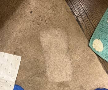 A easy patch on carpet surrounded by textured mats and papers suggests most neatly-liked vacuuming or cleaning, highlighting cleanliness