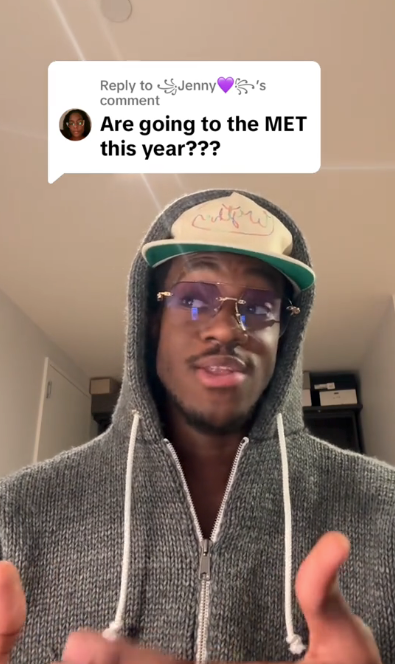 Person in hoodie and cap responds to a comment asking if they're attending the MET this year