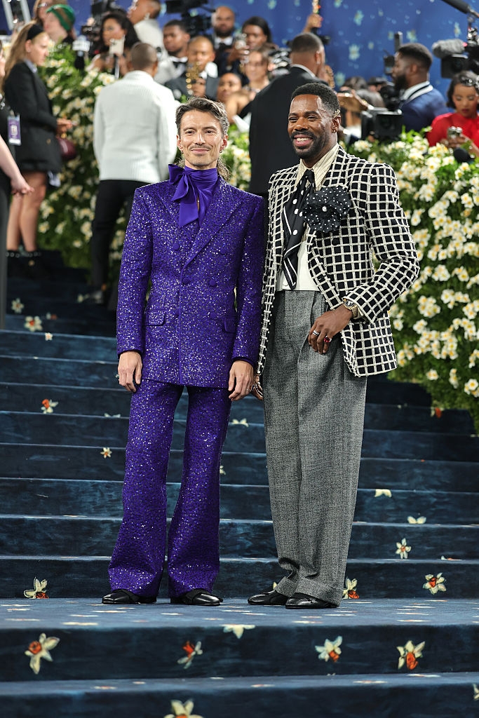 Raúl in a bold glittery monochrome suit, and Colman in a plaid jacket with solid pants and a polka dot tie