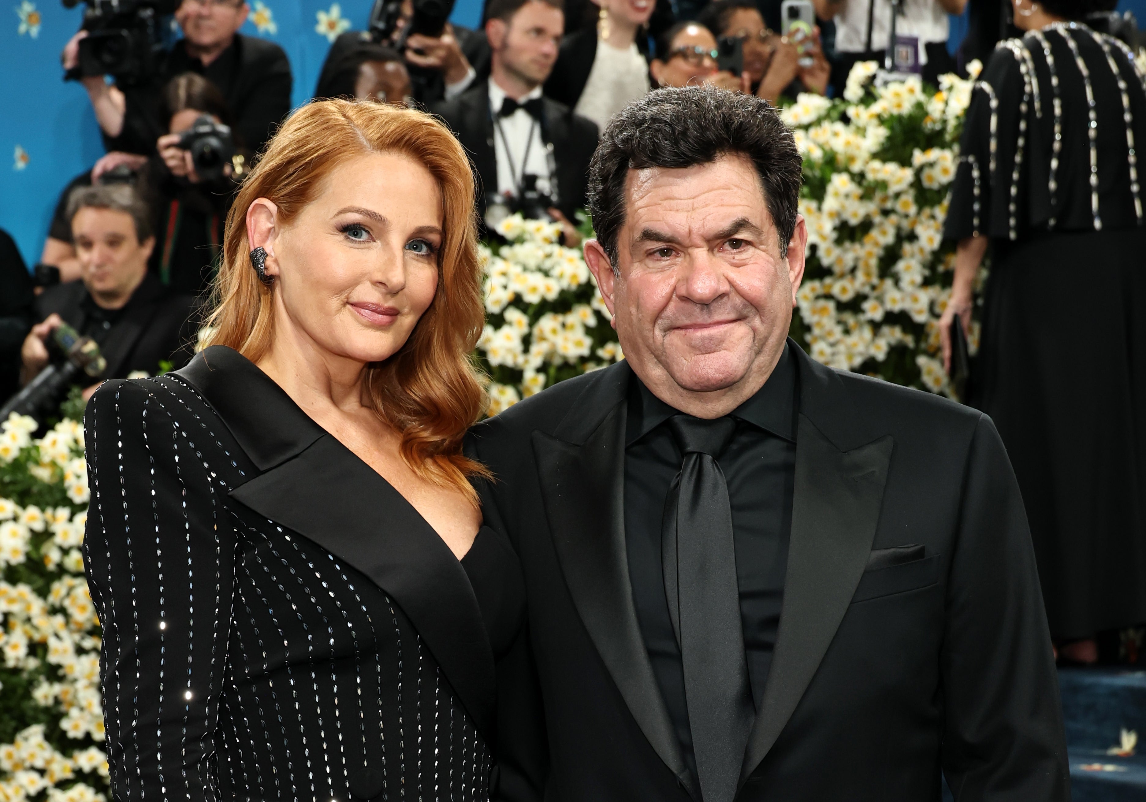 her dress has silver stripes, and his suit is all monochrome