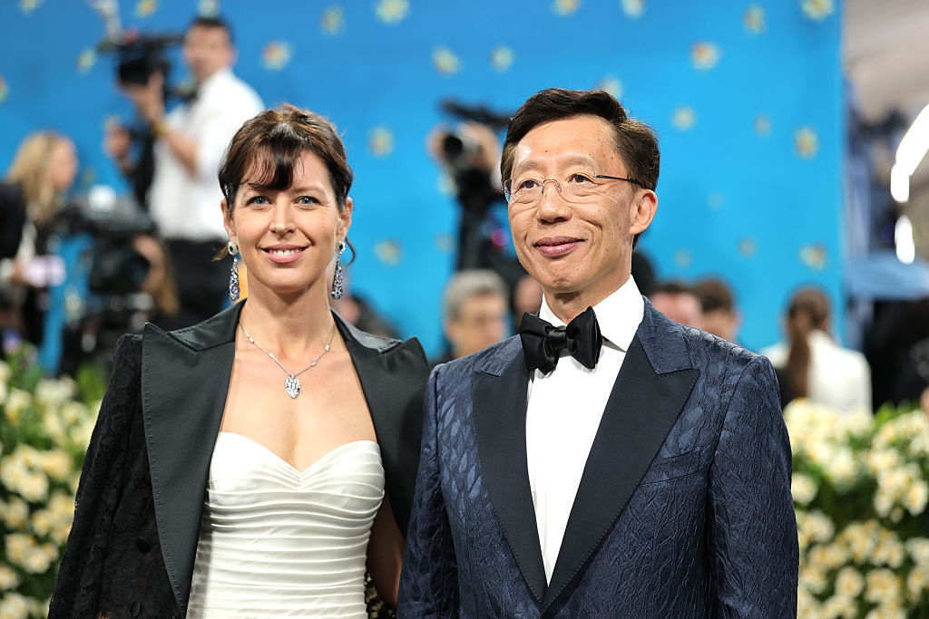close-up showing her large pendant necklace and his oversized bowtie
