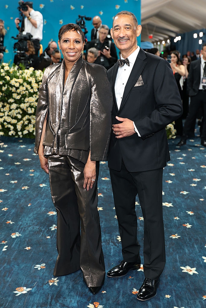 Speaker Adams wears a metallic suit, her husband a classic tuxedo