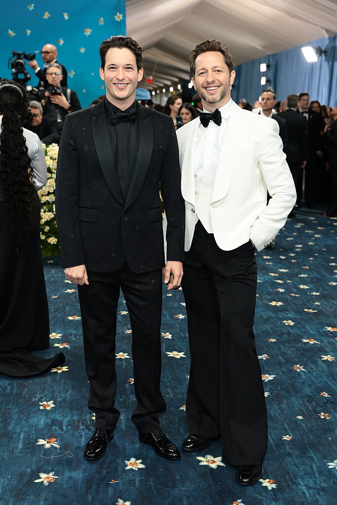 the couple in contrasting tuxes