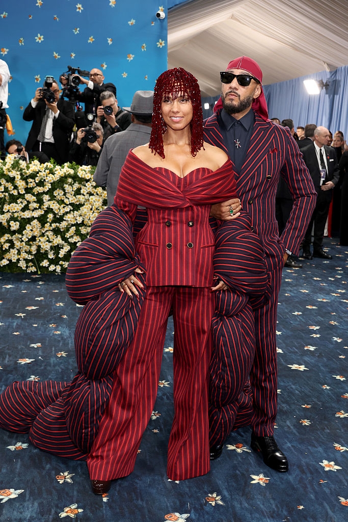 the couple in matching pinstripe outfits pose on the red carpet