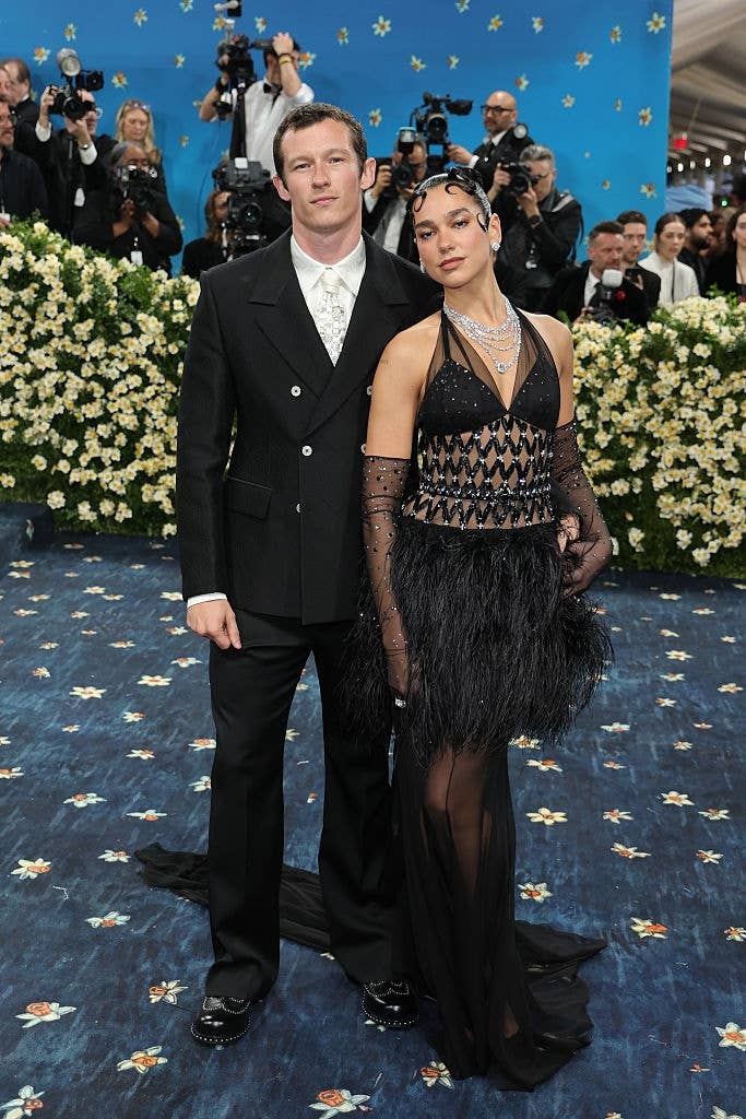 Social media trends Viral content Trending hashtags Social media updates Trending memes and videos Callum wears a suit, and Dua wears a sheer, feathered dress with gloves