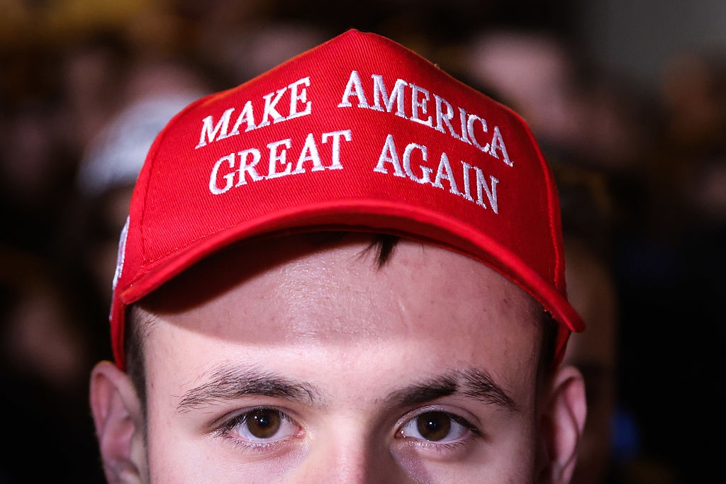 Person wearing a hat with the slogan "Make America Great Again" visible at the front