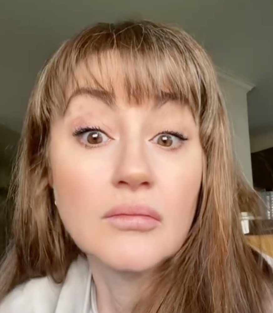 Person with long hair looks directly at camera, appearing thoughtful. Text on image reads "ONLINE CRITIQUING." TikTok username present