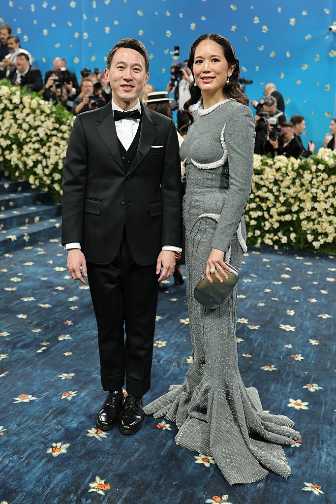 Vivian wears a textured gown with unique detailing; Shou Zi Chew is in a classic tuxedo