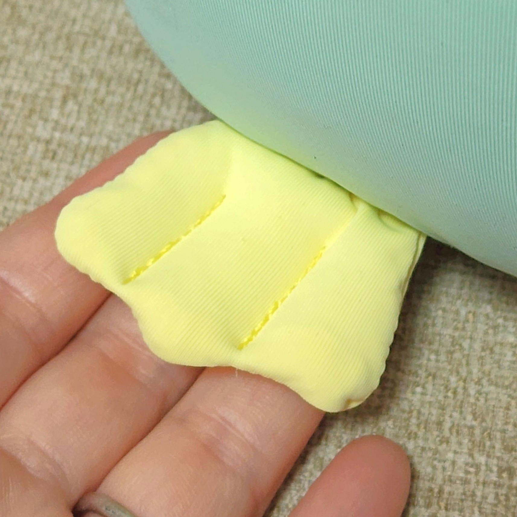 ふわふわした黄色いアヒル足が手のひらに乗っている。