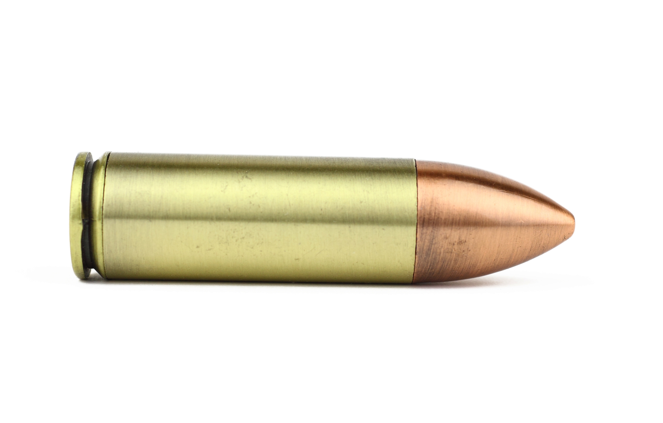 A close-up image of a single bullet lying horizontally against a plain white background