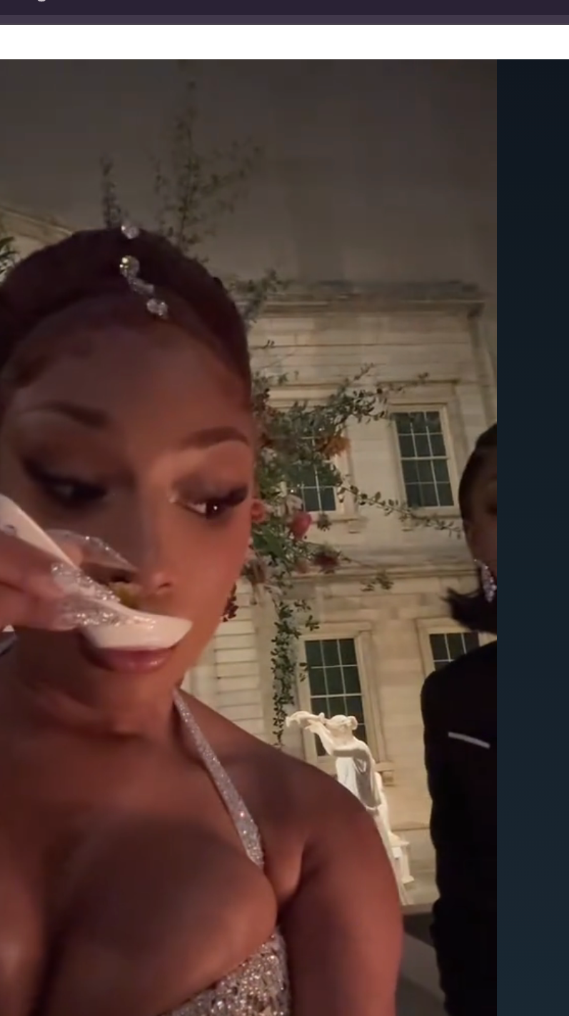 Megan Thee Stallion in glamorous attire tasting a snack at an event