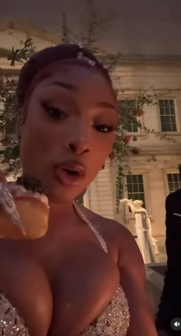 Megan Thee Stallion tasting food at the Met Gala