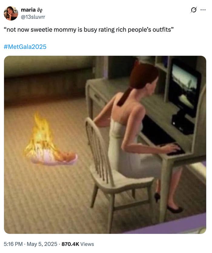 A meme showing a woman in a beige dress at a computer, ignoring a fire on the floor, with a caption about rating rich people&#x27;s outfits for the Met Gala 2025