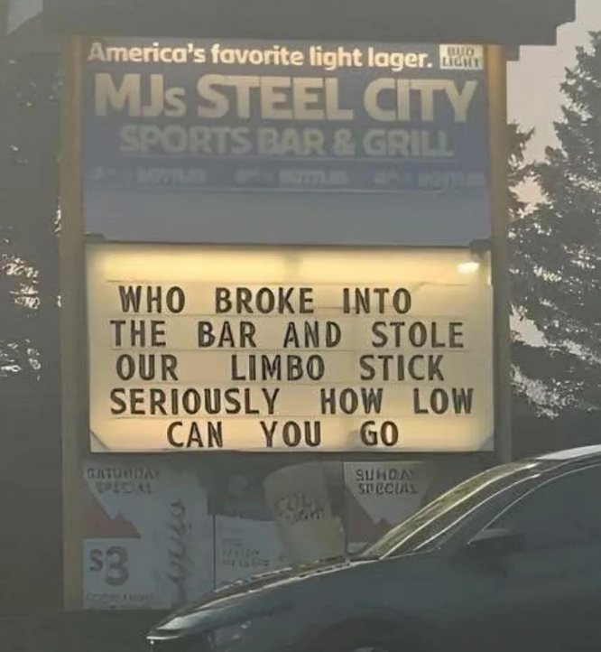 Sign outside MJ's Steel City Sports Bar humorously asks who stole their limbo stick, finishing with "Seriously, how low can you go?"