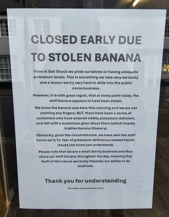 Sign on a door reads: "Closed early due to stolen banana" with a humorous story about potassium and theft