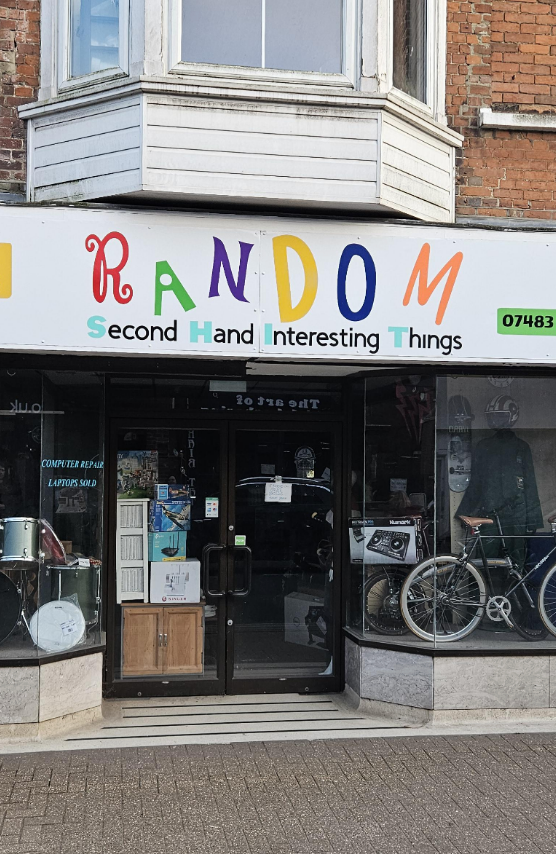 Storefront of "Random Second Hand Interesting Things" with letters highlighted so it also reads "Random SHIT"