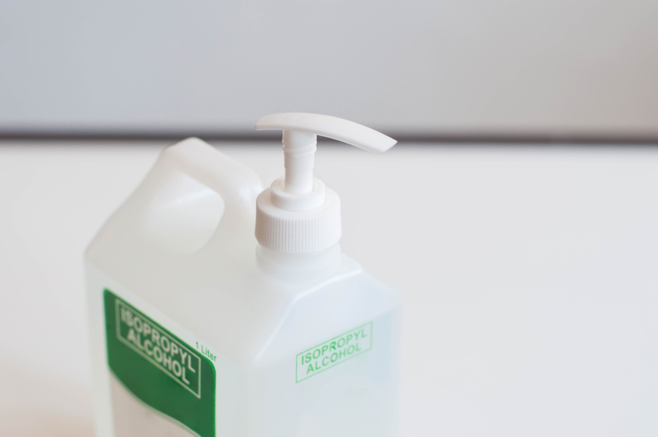 Pump bottle of isopropyl alcohol on a clean surface