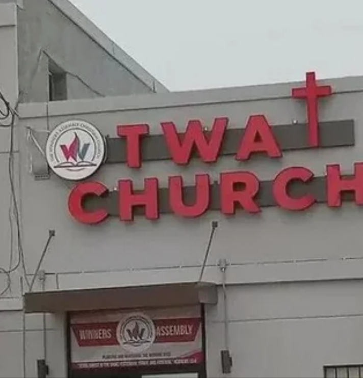 Sign for "Twa Church" with a cross integrated into the text so that it appears to read "Twat Church"
