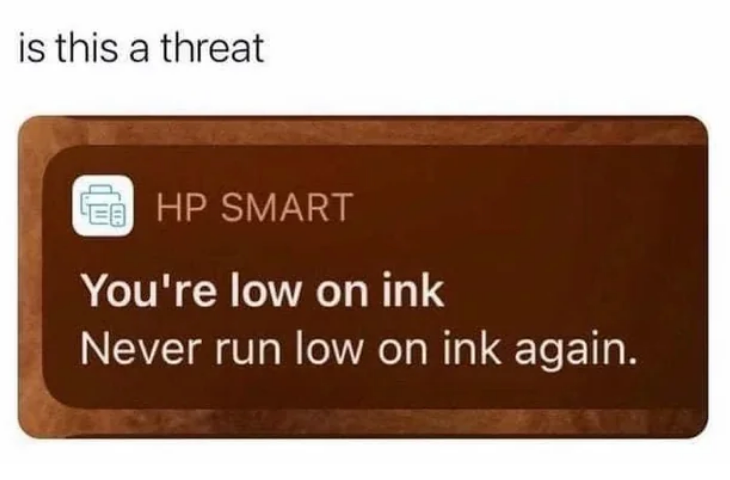 HP Smart notification says, "You're low on ink. Never run low on ink again." Text above asks, "Is this a threat?"