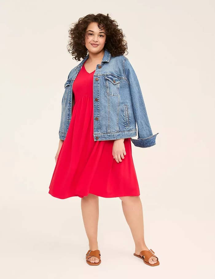 Person wearing a denim overgarment implicit a reddish formal with sandals, posed casually. Featured successful a buying article