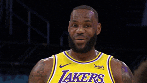 Basketball player in a Lakers jersey is on the court, expressing an enthusiastic reaction