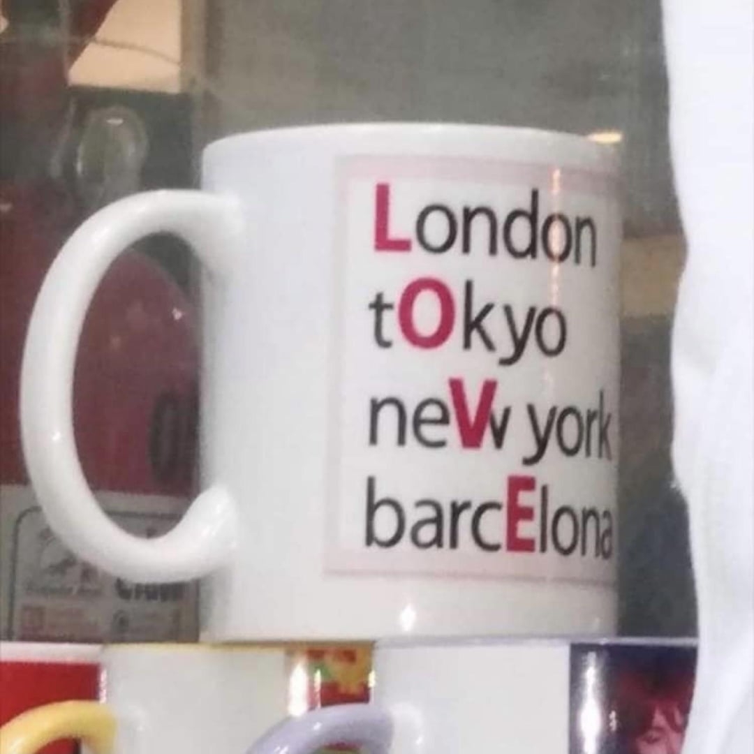 Mug with text: "London, Tokyo, New York, Barcelona" with the letters L, O, V, E highlighted