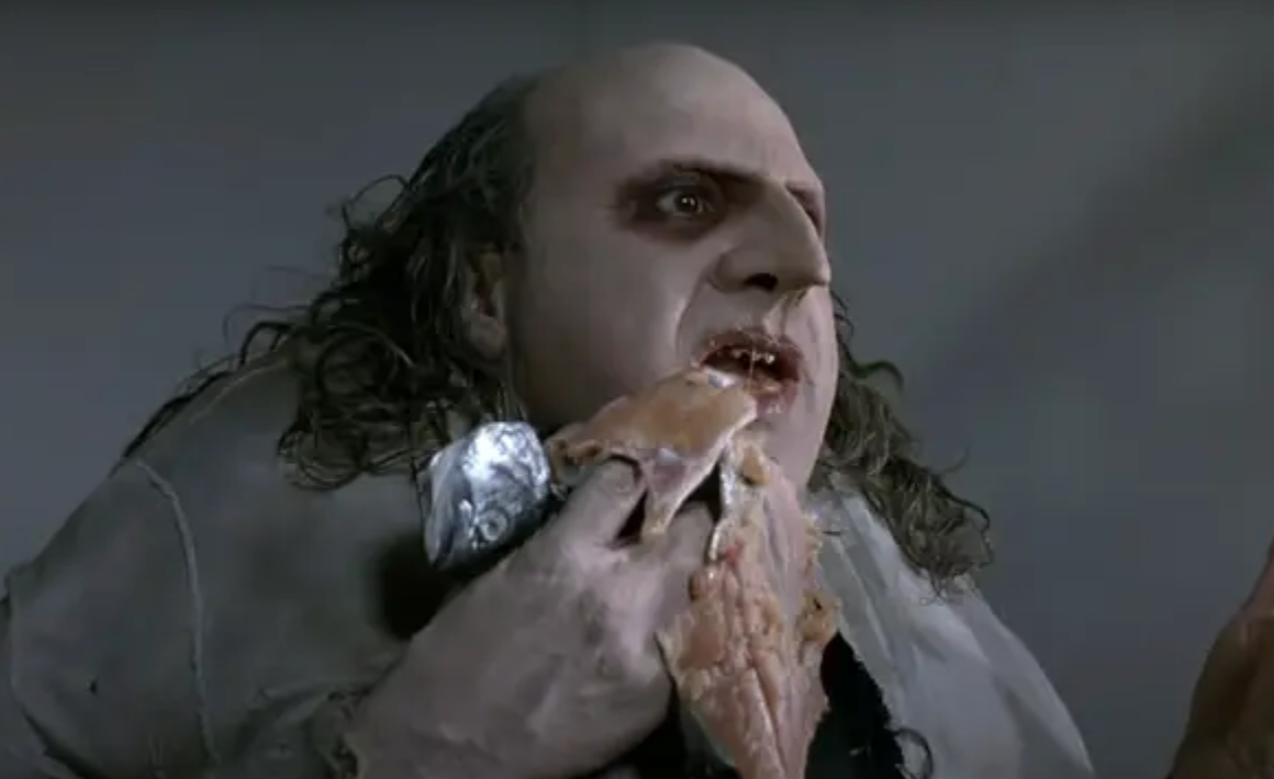 The Penguin eating a raw fish