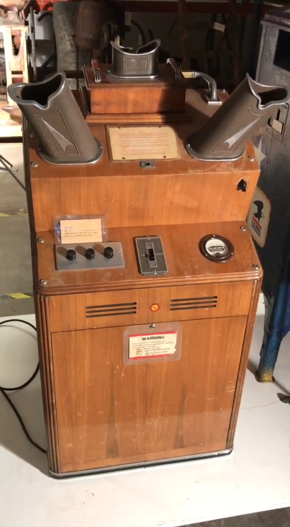 Vintage wooden arcade machine with various controls and dials, featuring retro design elements
