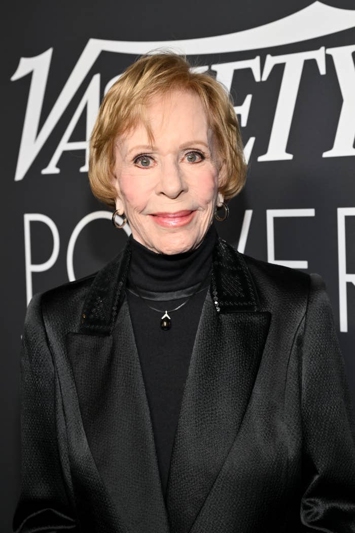 Person in elegant blazer and turtleneck at a Variety event backdrop