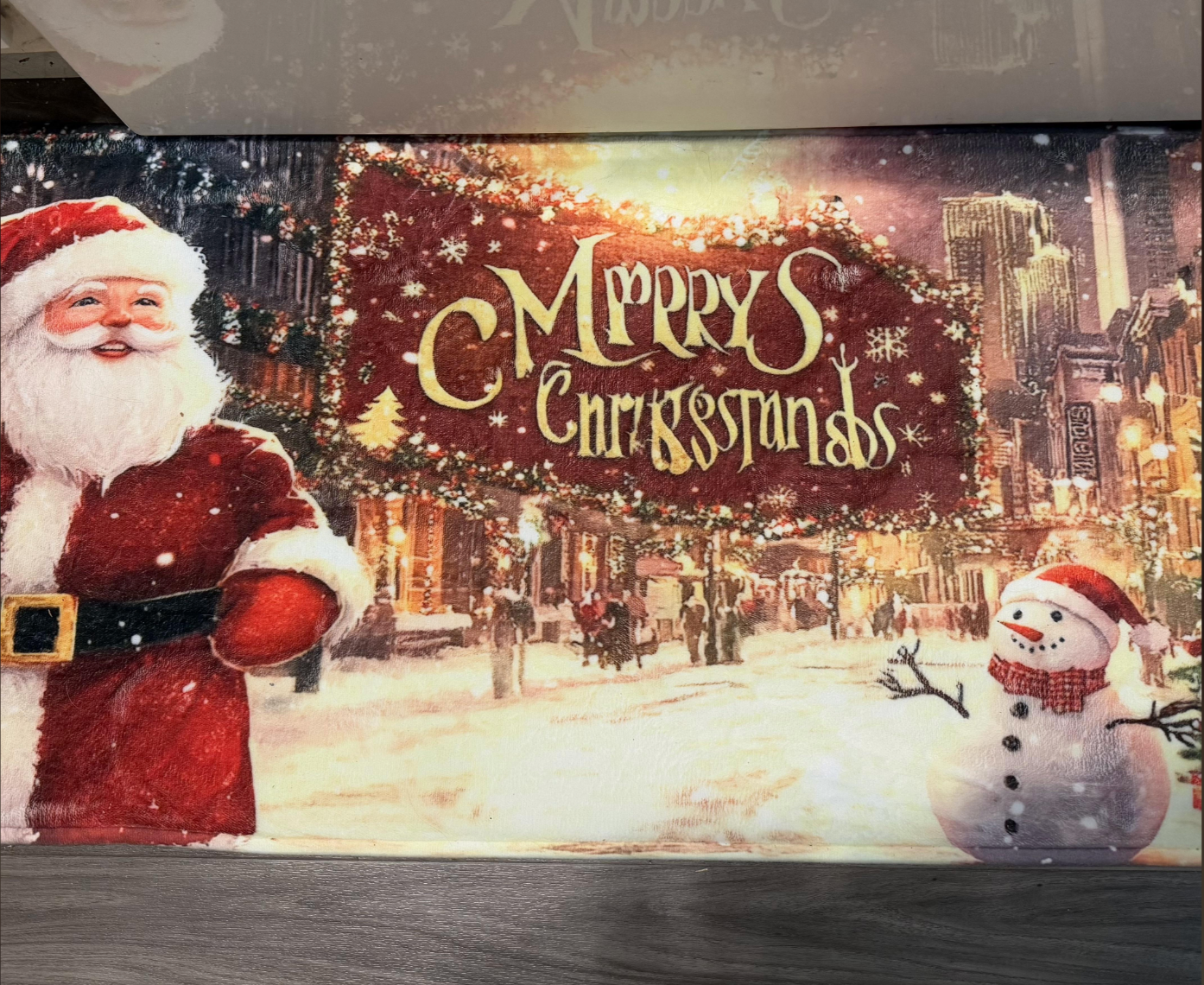 Santa and snowman in a festive city scene with a sign reading "Merry Christmas."