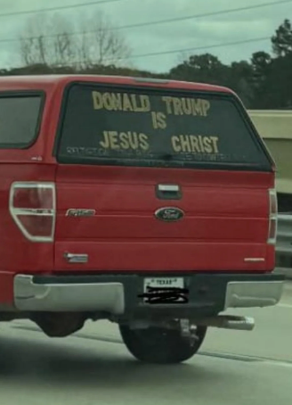 Truck with "Donald Trump is Jesus Christ" sign on the rear window