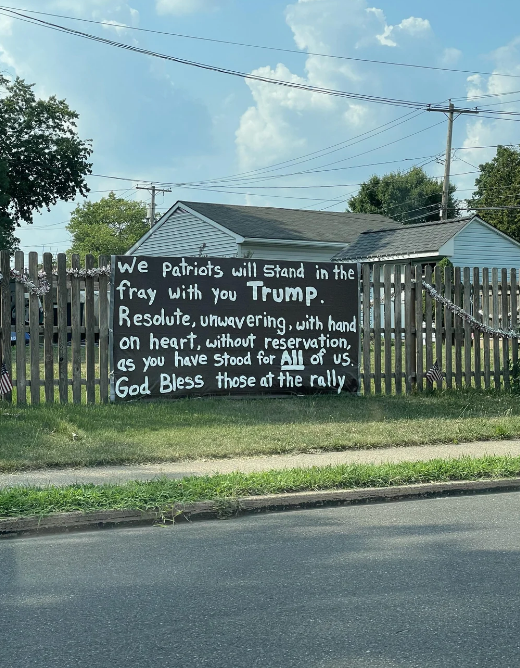 Sign on a fence reads: "We Patriots will stand in the fray with you Trump…" and "God Bless those at the rally"