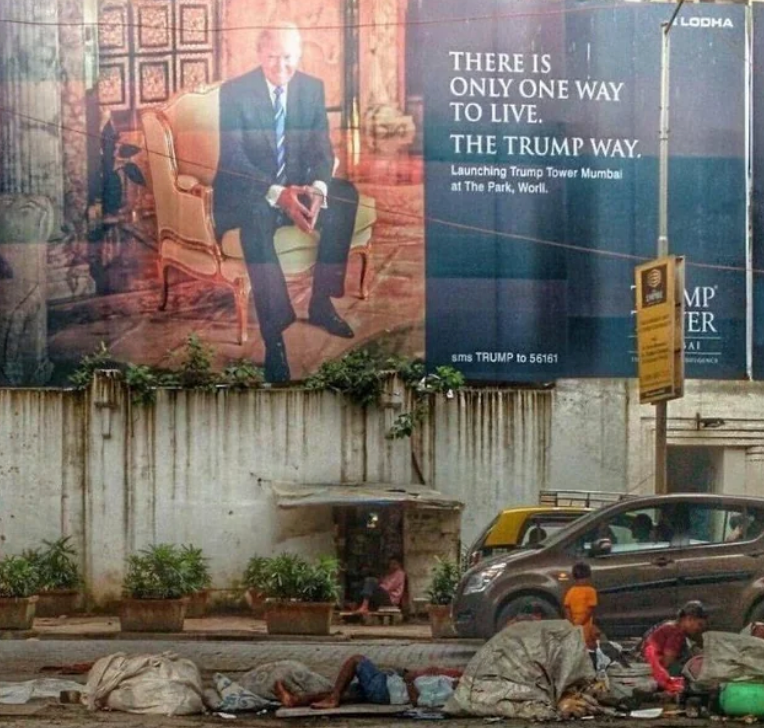 Billboard promoting Trump Tower Mumbai above a busy street with people and vehicles