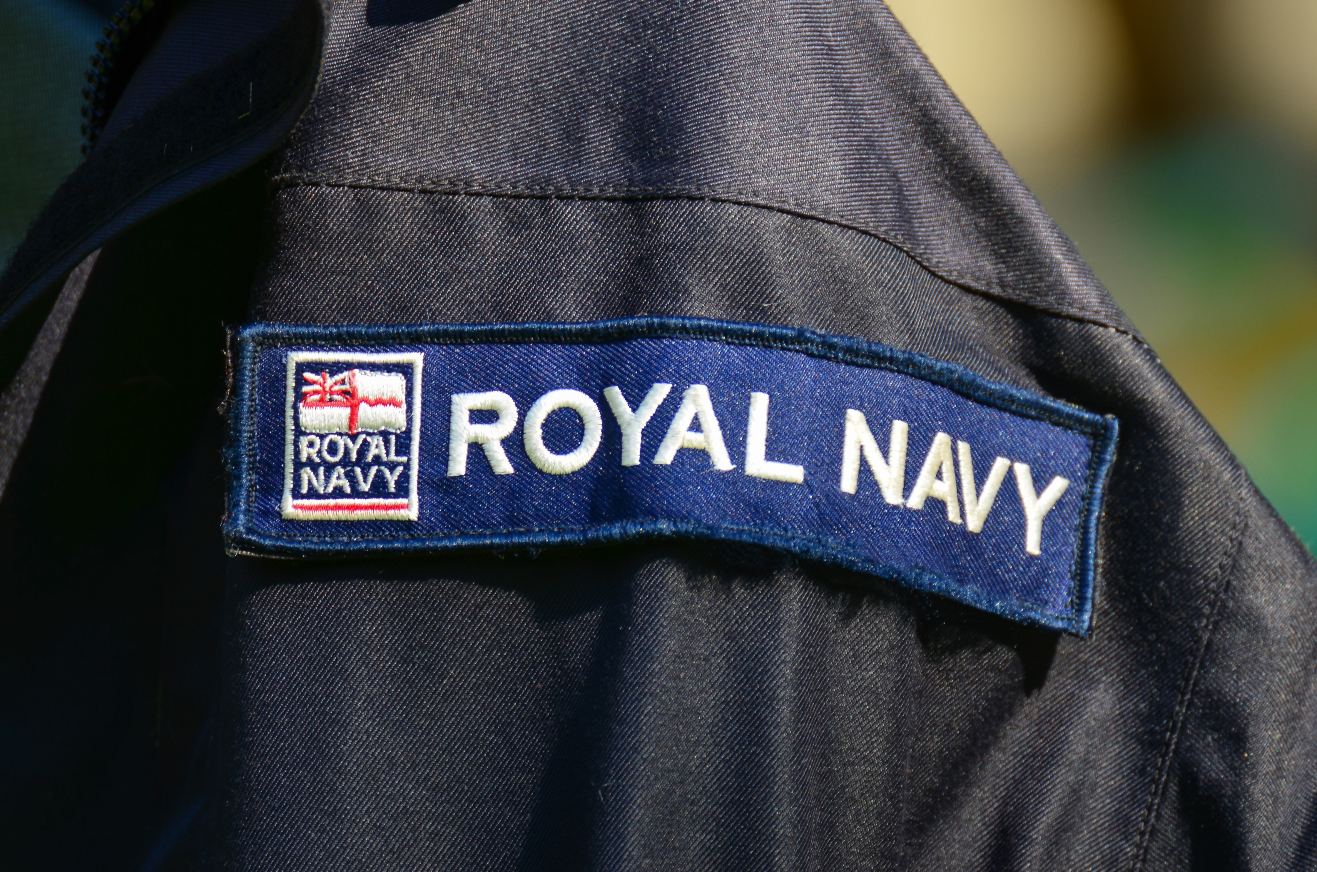 Patch on a uniform with the text "Royal Navy" and a flag emblem