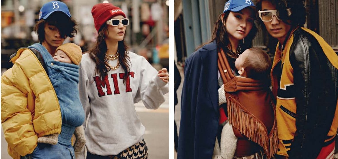 Fashionable individuals in casual streetwear, including jackets, hoodies, and baseball caps, carrying infants in baby carriers on a city street