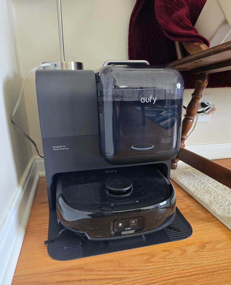 Reddit post showing a robot vacuum discussion page; a user reviews a Eufy E28 model after two weeks of use