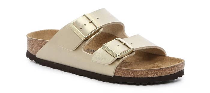 Two-strap sandal with adjustable buckles connected a cork footbed, perfect for comfortableness and casual wear