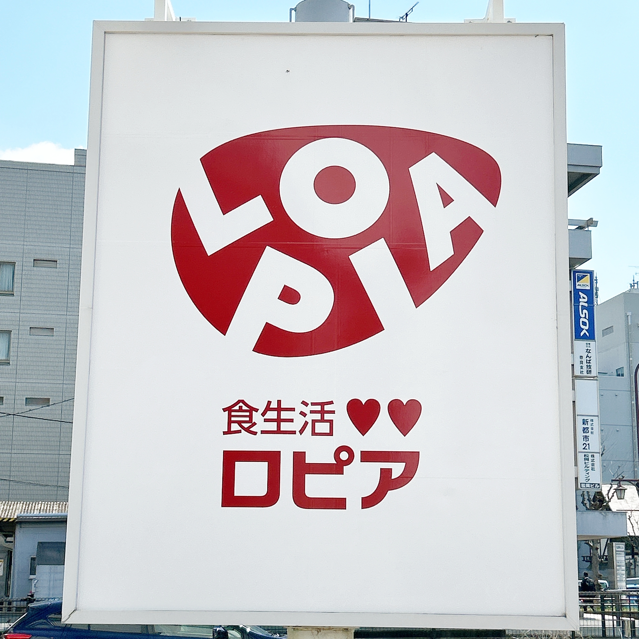 ロピアの看板が写された広告画像。背景には建物が見える。