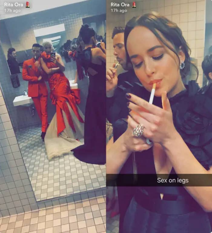 Celebrities in glamorous outfits in a bathroom. One lights a cigarette, others pose in a mirror selfie. Text on image mentions "Rita Ora"
