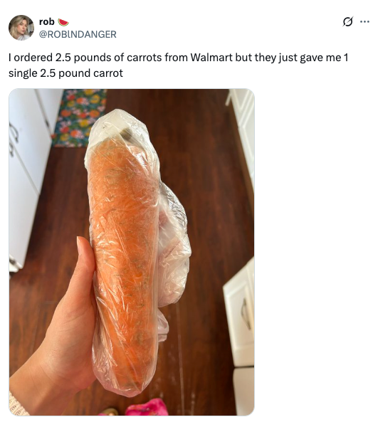 A hand holds a large, single carrot wrapped in plastic, highlighted by a tweet about an unexpected grocery order from Walmart