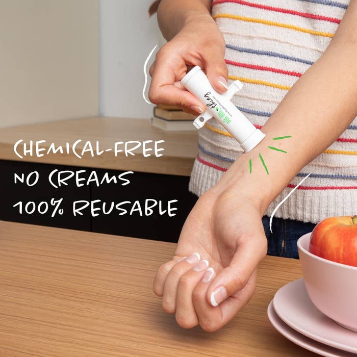 Person utilizing a achromatic  instrumentality  connected  arm, labeled &quot;chemical-free,&quot; &quot;no creams,&quot; &quot;100% reusable,&quot; adjacent   a array  with a vessel  of apples