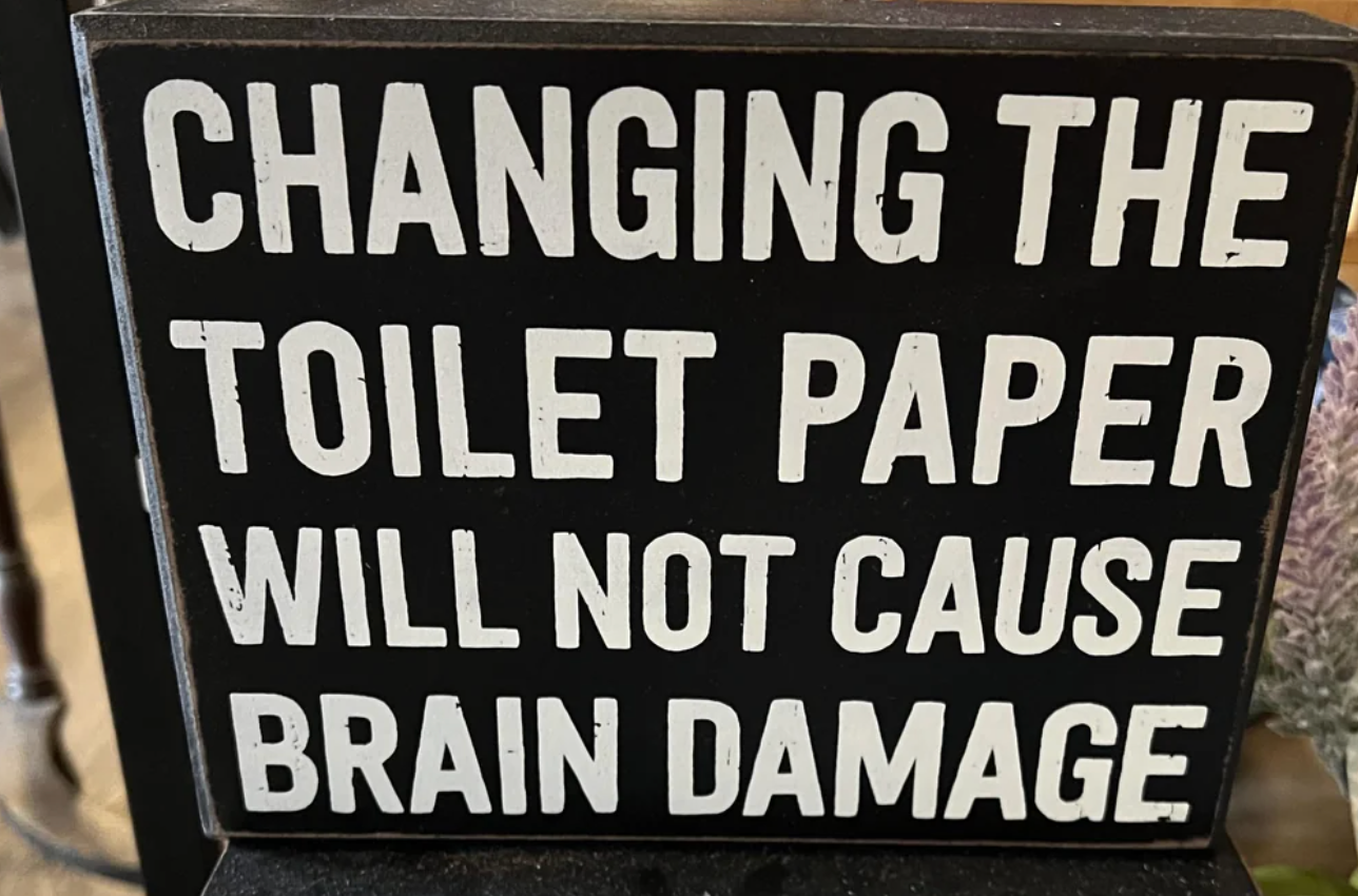 Sign reads: "Changing the toilet paper will not cause brain damage."