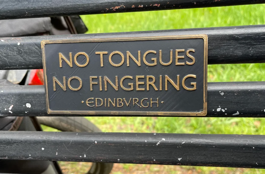 Sign on a metal fence reads, "No Tongues, No Fingering, Edinburgh."